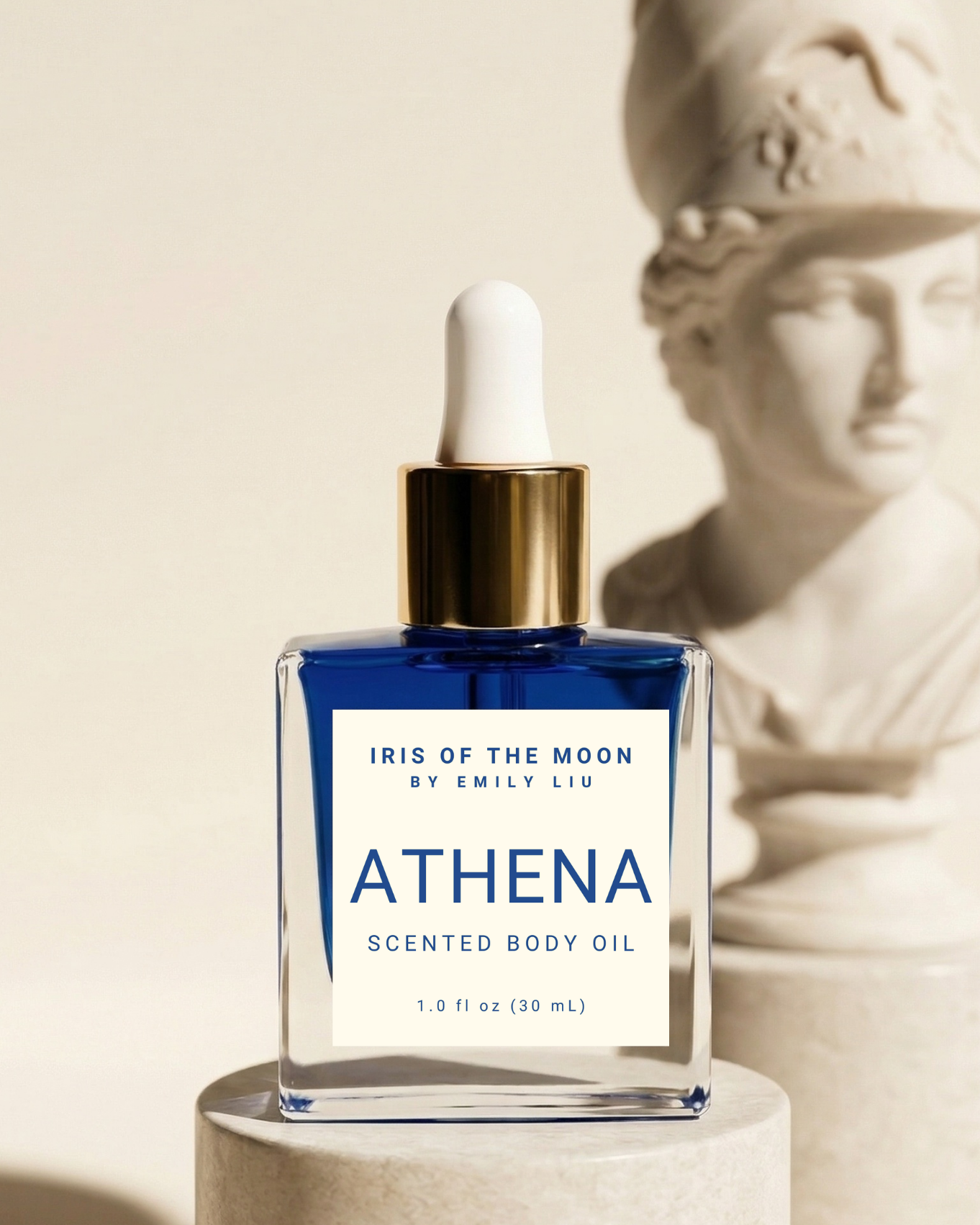 Athena scented body oil bottle with a classical statue in the background