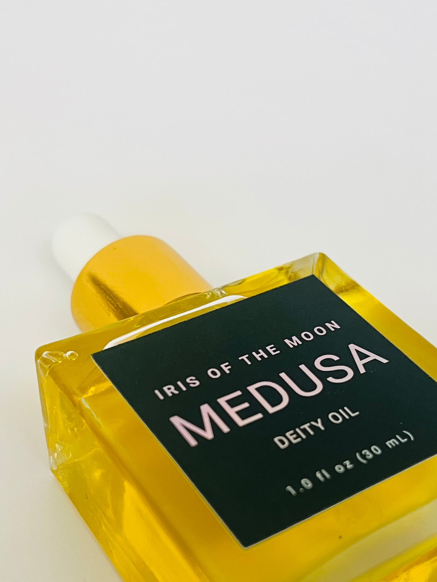 Bottle of 'Iris of the Moon Medusa Deity Oil' on a white background