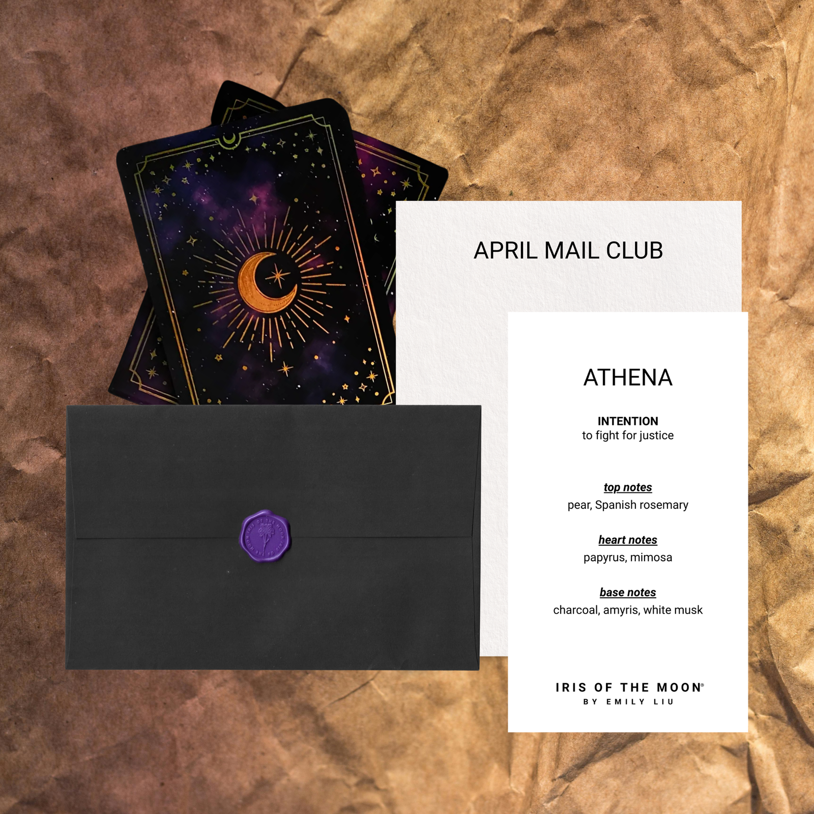 Black envelope with purple wax seal, tarot cards, and a card titled 'April Mail Club Athena' on a textured brown background.