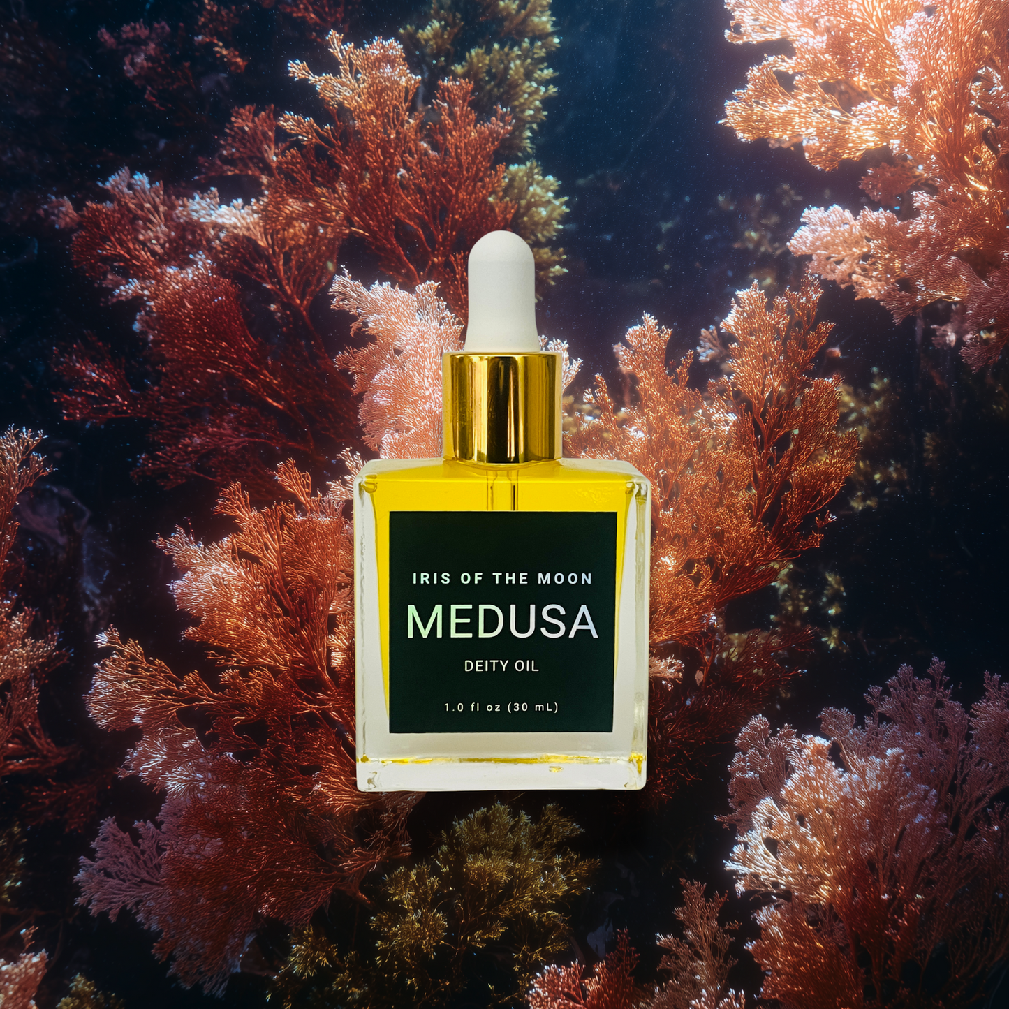 Perfume bottle labeled 'Medusa' by Iris of the Moon on a coral background