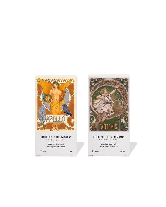 Two boxed fragrance products from Iris of the Moon, featuring Apollo on the left and Artemis on the right, shown side by side on a white background with soft shadows.