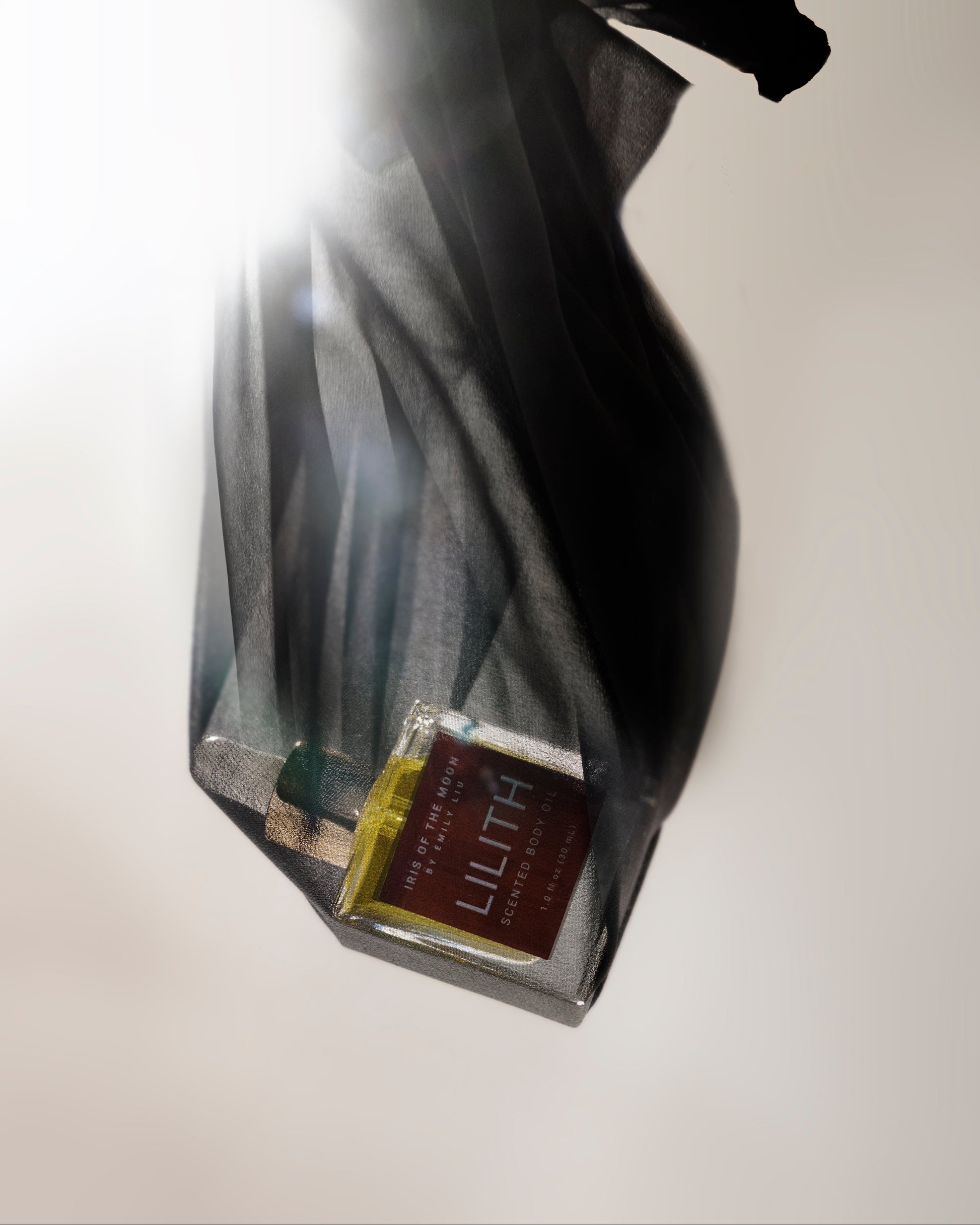 Perfume bottle with a visible label on a light background