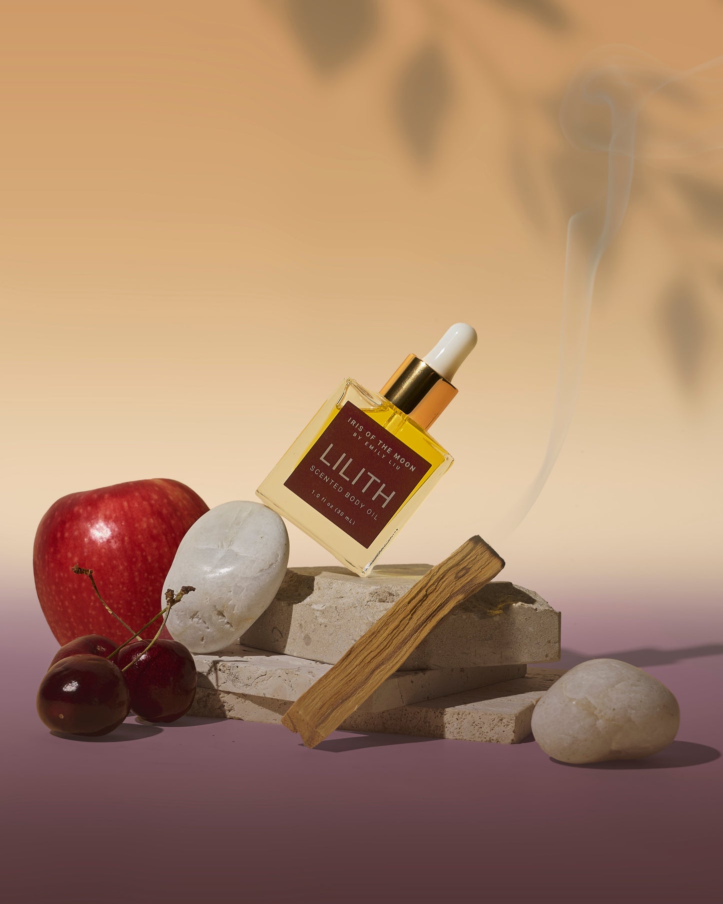 Perfume bottle labeled 'Lilith' with an apple and stones on a gradient background
