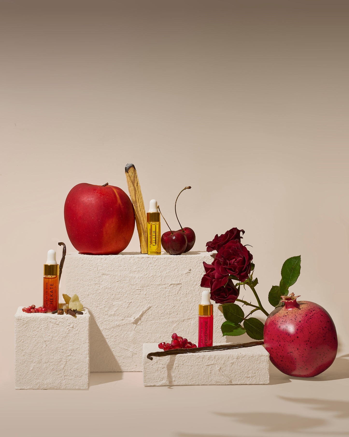 Still life arrangement with apples, flowers, and candles on a textured surface.