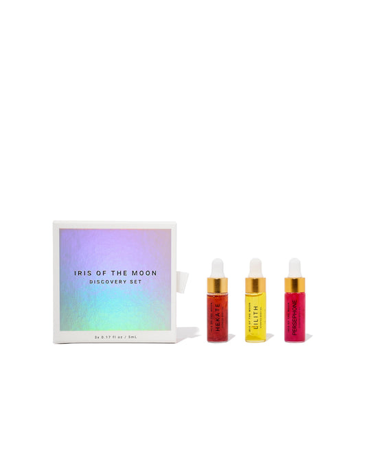 Set of small bottles with colorful labels on a white background, featuring 'Iris of the Moon' packaging.