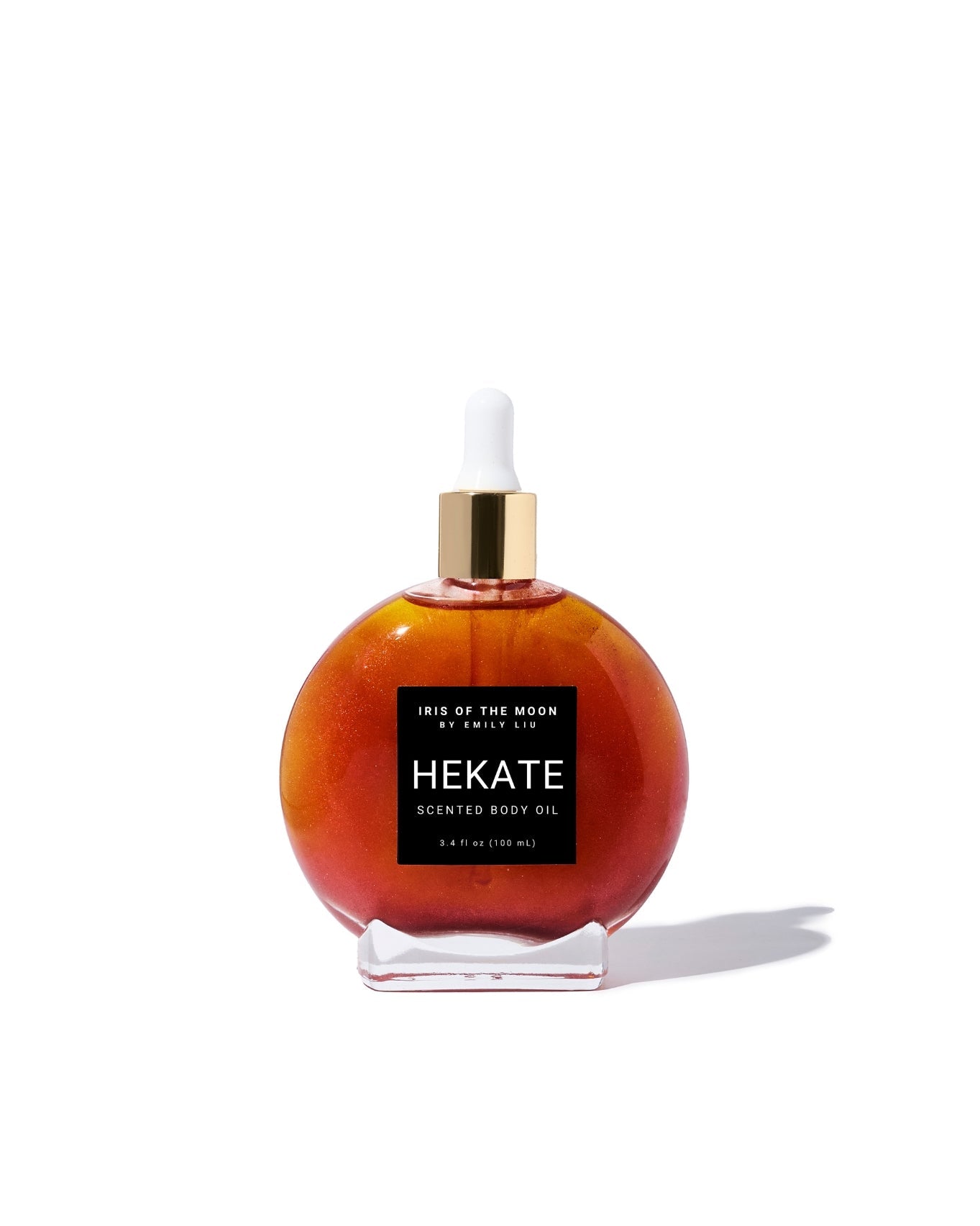 Red bottle of Hekate body oil with a dropper on a white background