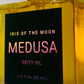 Gold bottle of 'Iris of the Moon Medusa Deity Oil' with a dark green label.